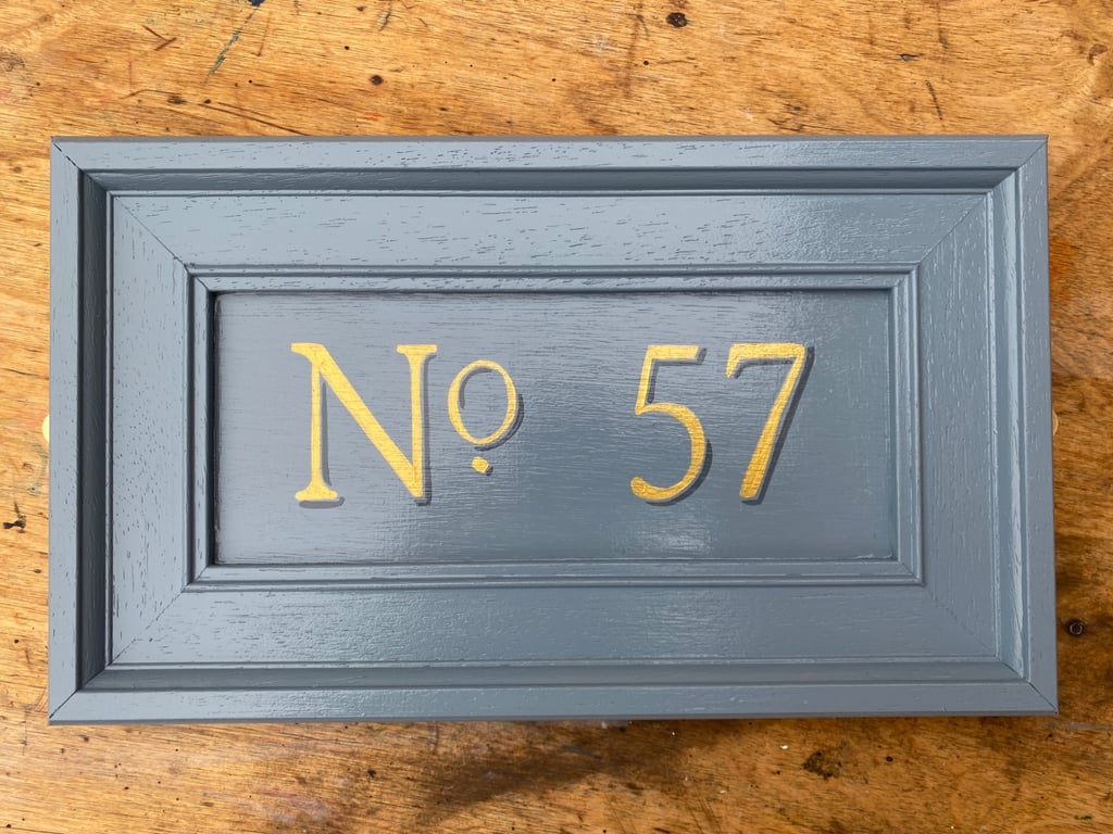 Gold numbered, painted door address plaque