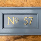 Gold numbered, painted door address plaque