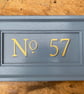 Gold numbered, painted door address plaque
