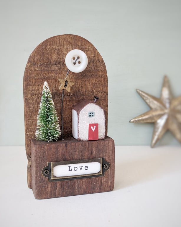 Festive Wooden Cottage Scene with Star and Moon