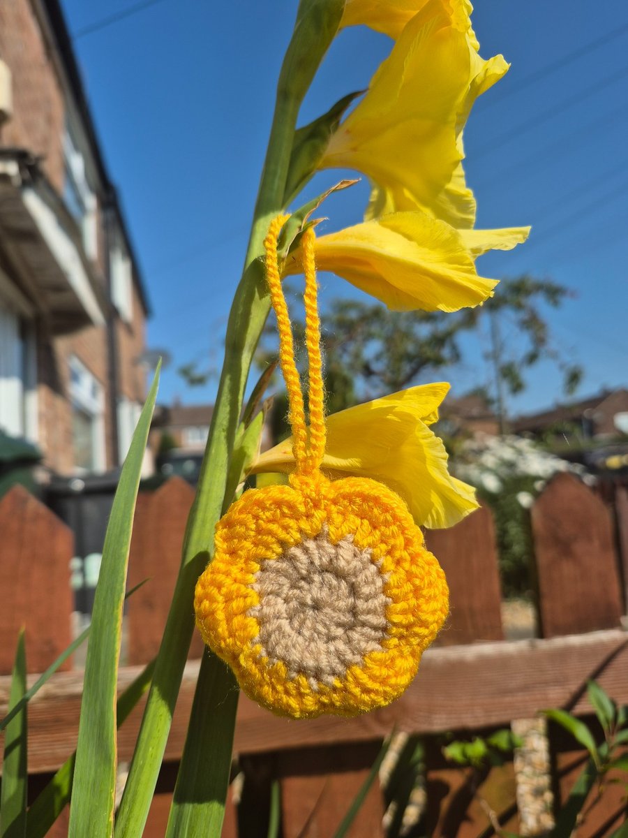 Flower shaped bag charm with small storage space.