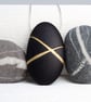 Black Pebble prndant with gilded lines which hangs on a sterling silver chain 