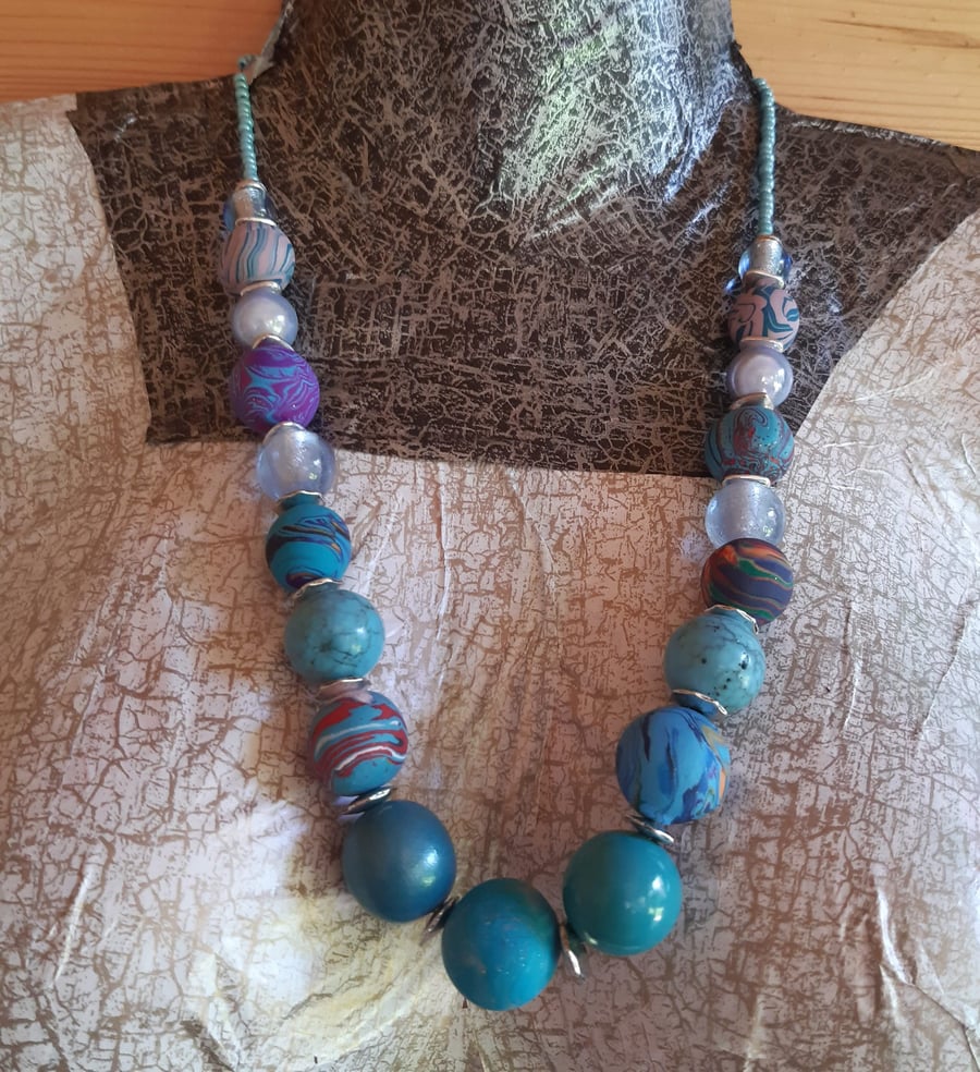 Longer length polymer clay necklace in shades of turquoise