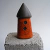 Orange raku glazed round house