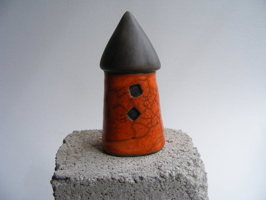 Orange raku glazed round house