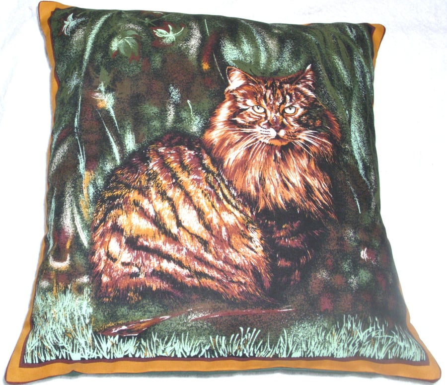 Lovely dark ginger and black fluffy Tabby cat sitting in a garden cushion