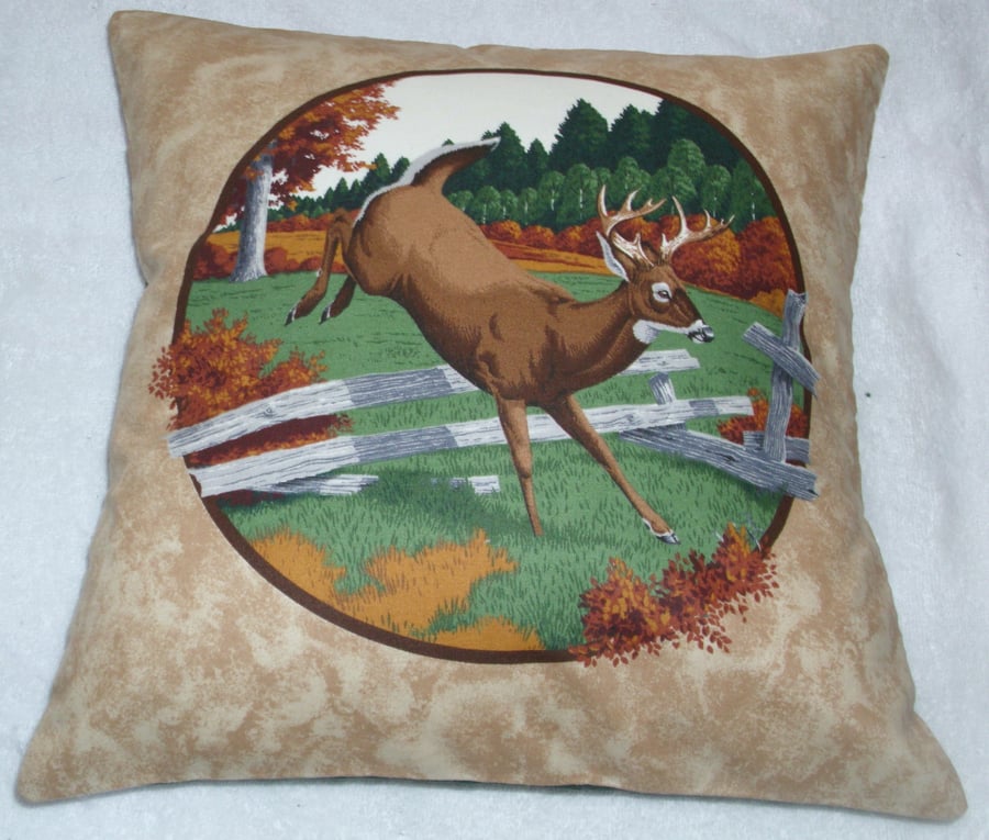 Stag leaping over a fence in a field by an Autumnal forest cushion