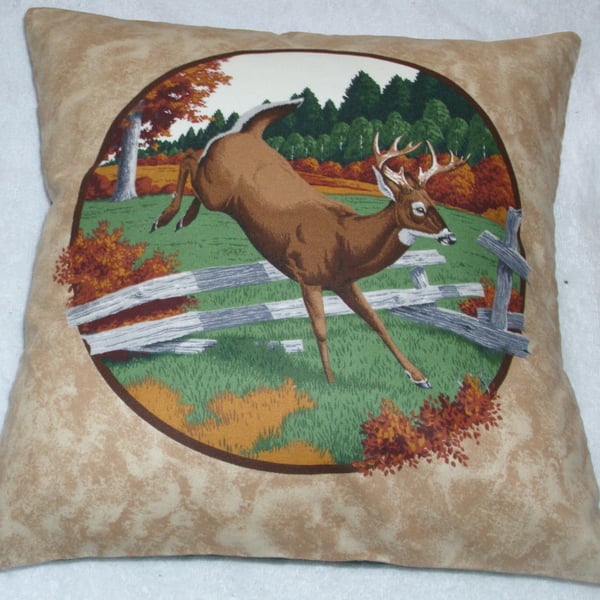 Stag leaping over a fence in a field by an Autumnal forest cushion