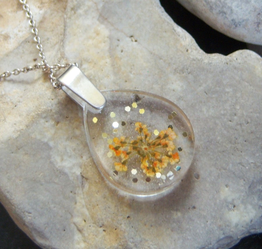 Resin pendant with dried flowers and sterling silver