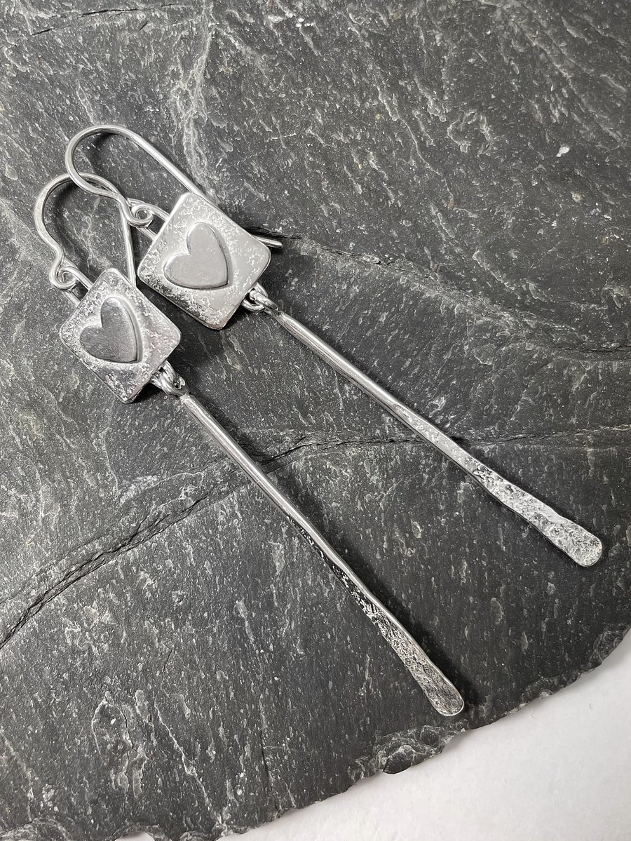 Silver long dangly earrings with hearts.