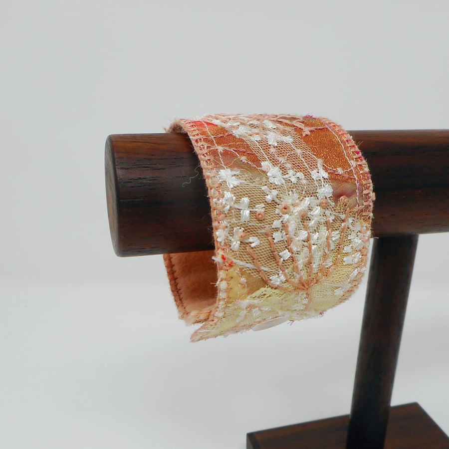 Textile jewellery cuff made from lace and silk with embroidered details