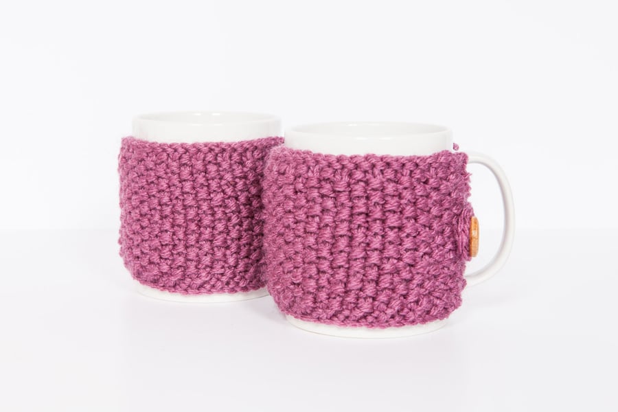 Pair of knitted mug cosies, cup cosy, coffee cosy in berry. Coffee mug cosy