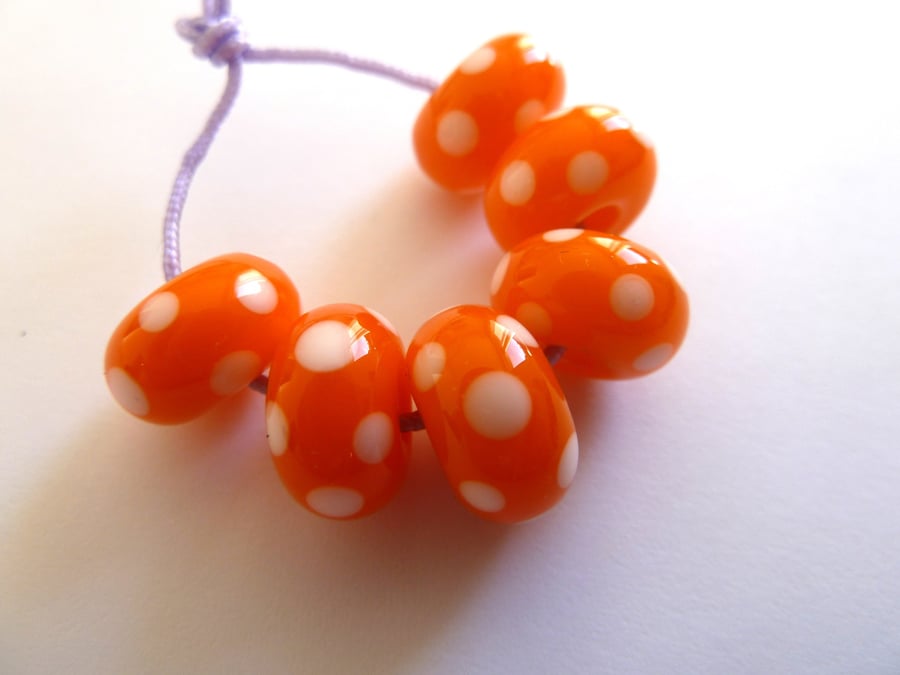 orange and white spot lampwork beads