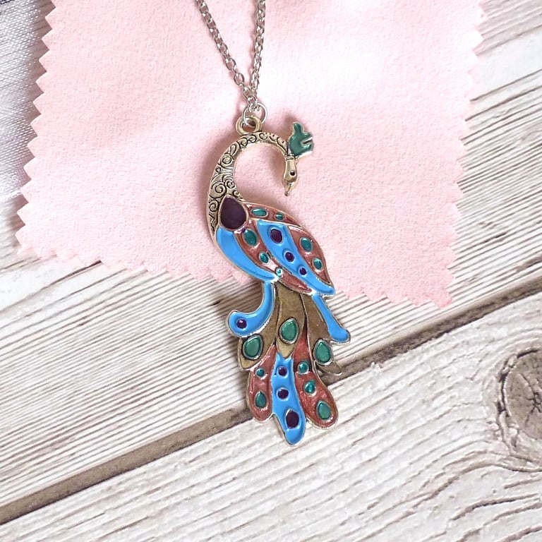 Sky blue peacock pendant with rose gold, turquoise and purple accents