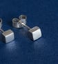 Silver cube stud earrings with a brush matte textured finish - Image 1