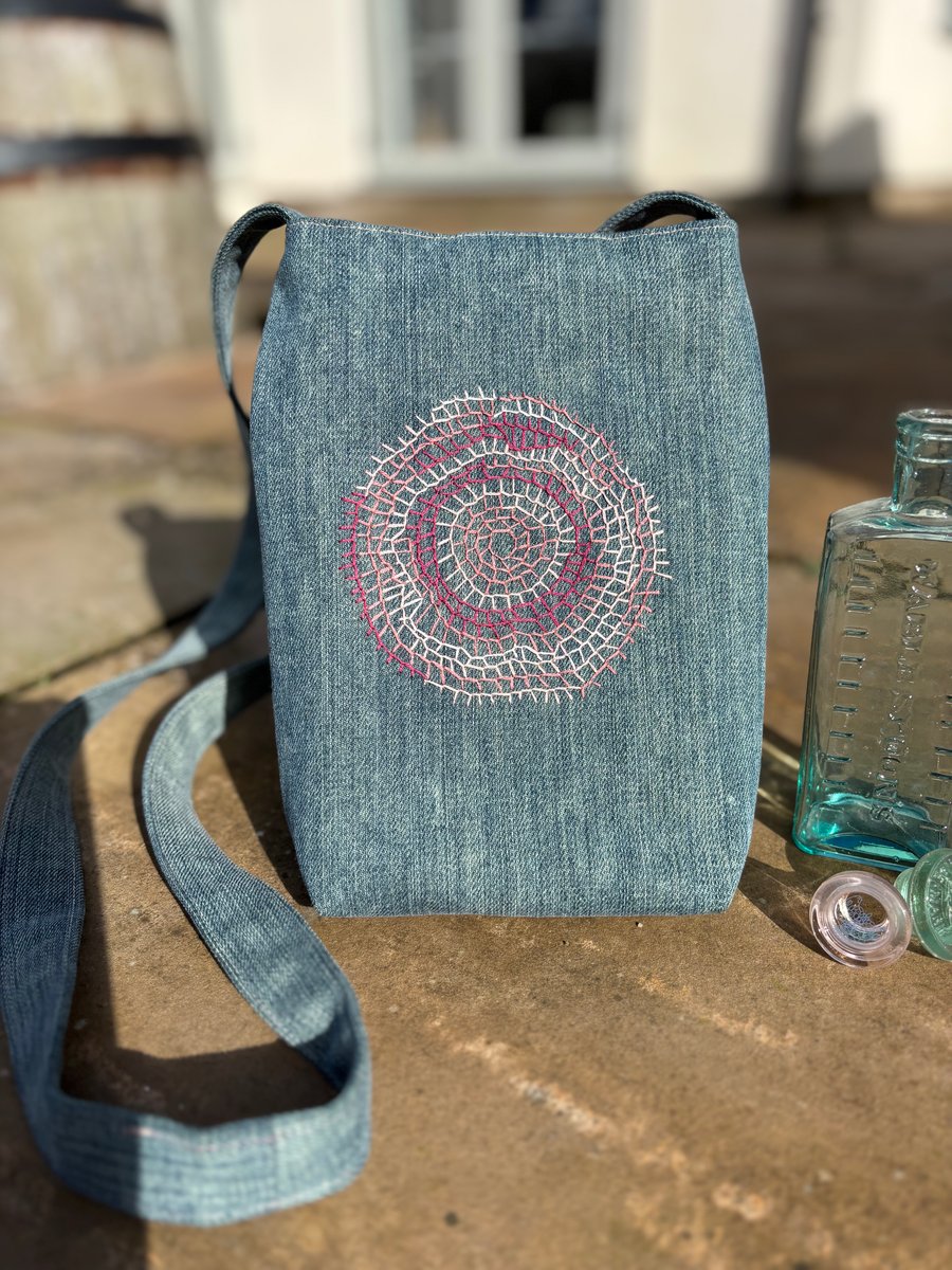 Denim crossbody bag with hand sewn embroidery detail