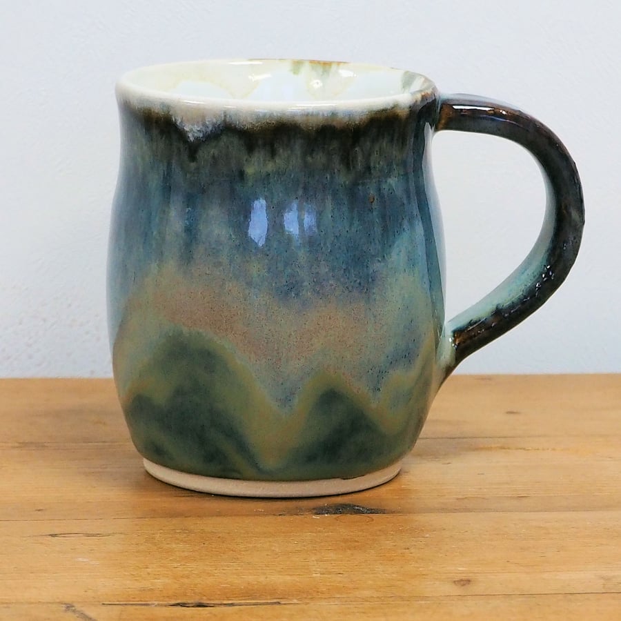 Pottery mug finished in multi-coloured blue and purple glaze, handmade