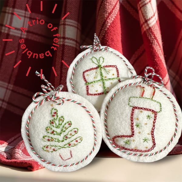 A trio of wool felt hanging decorations, baubles,stocking, gift,tree, candy cane