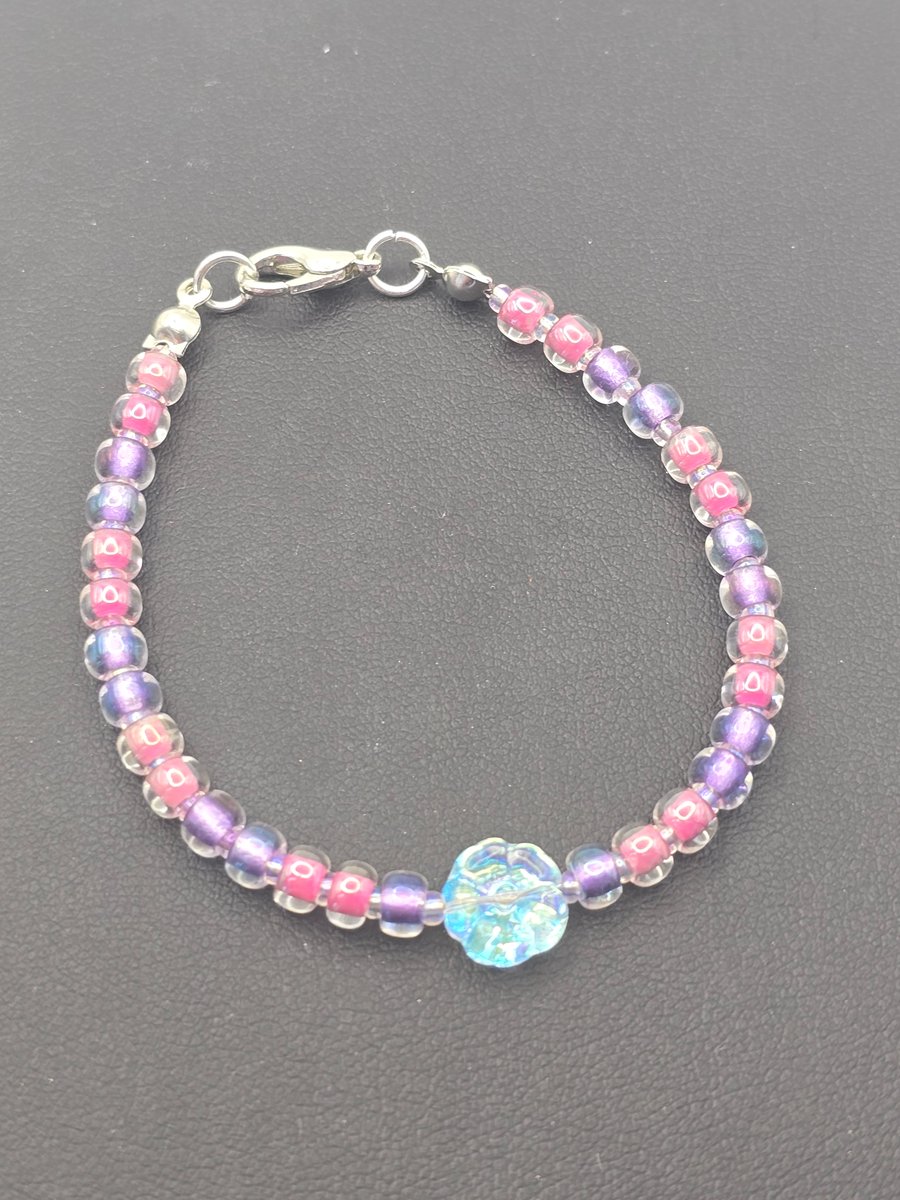 Kids pink and purple bracelet with clear crystal flower bead.