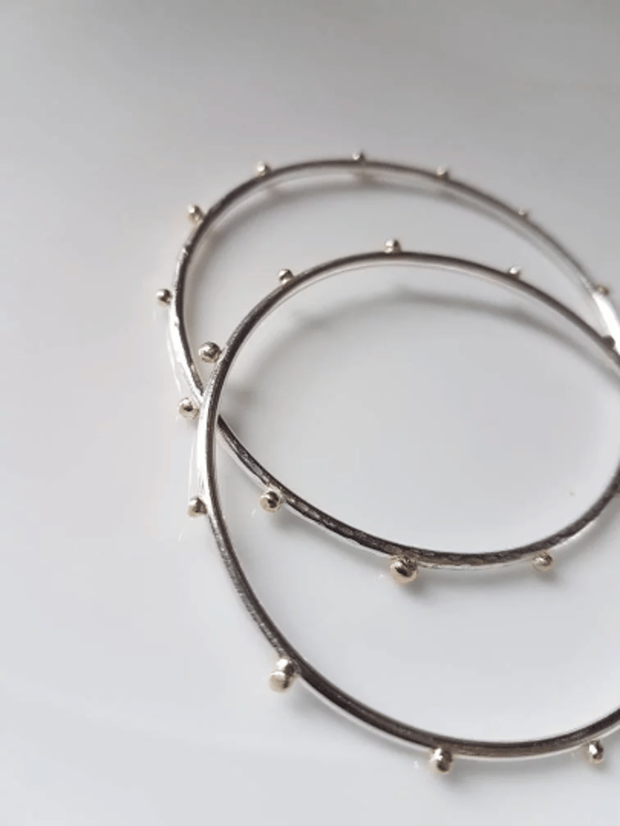 Sterling silver bangle with 9ct gold balls soldered to give a contemporary look