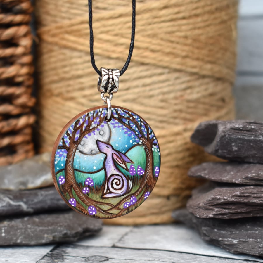 Moongazing hare with purple toadstools. Pyrography round wood pendant.
