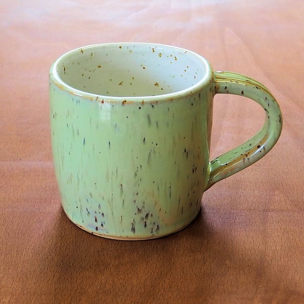 Stoneware pottery mug finished in a melon green glaze