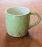 Stoneware pottery mug finished in a melon green glaze