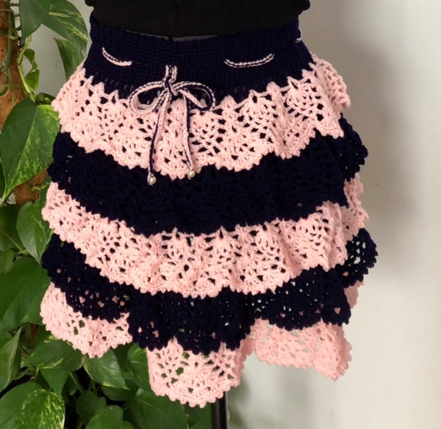 Crochet ruffle skirt. Navy blue and pink. Size small (8-10).