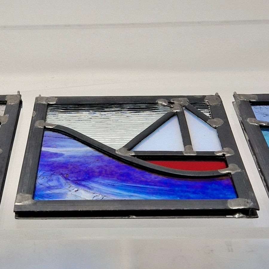 Stained glass red sailing boat and wave leaded hanging panel.