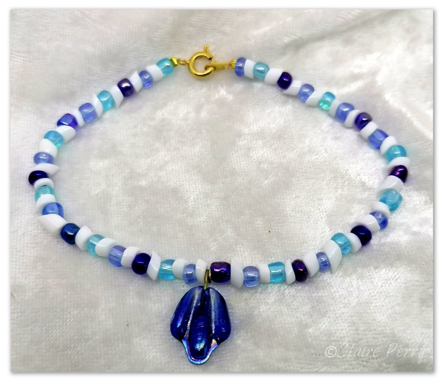 Seed bead bracelet mixed glass beads with a Blue glass charm.