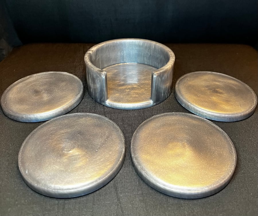 Silver set of 4 coasters with holder. 
