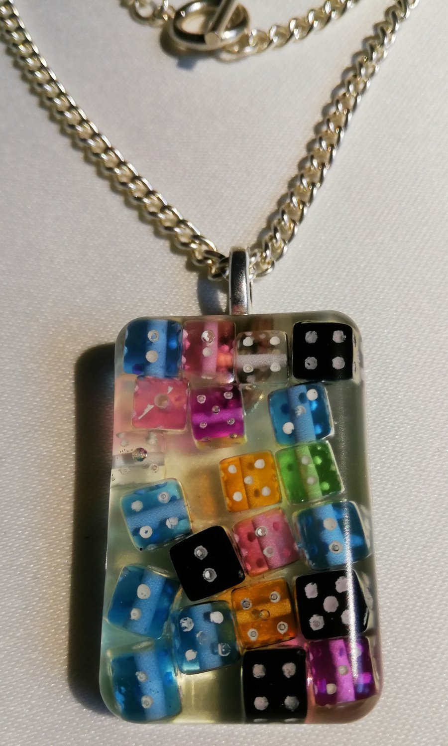 Handmade resin necklace with multicoloured dice on silver chain