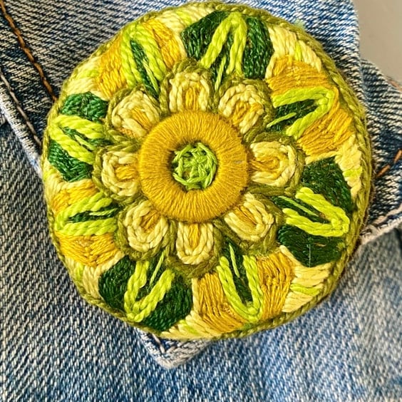 Stylised flower brooch hand embroidered in shades of green