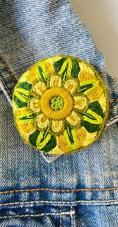 Stylised flower brooch hand embroidered in shades of green