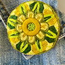 Stylised flower brooch hand embroidered in shades of green