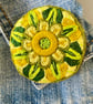 Stylised flower brooch hand embroidered in shades of green