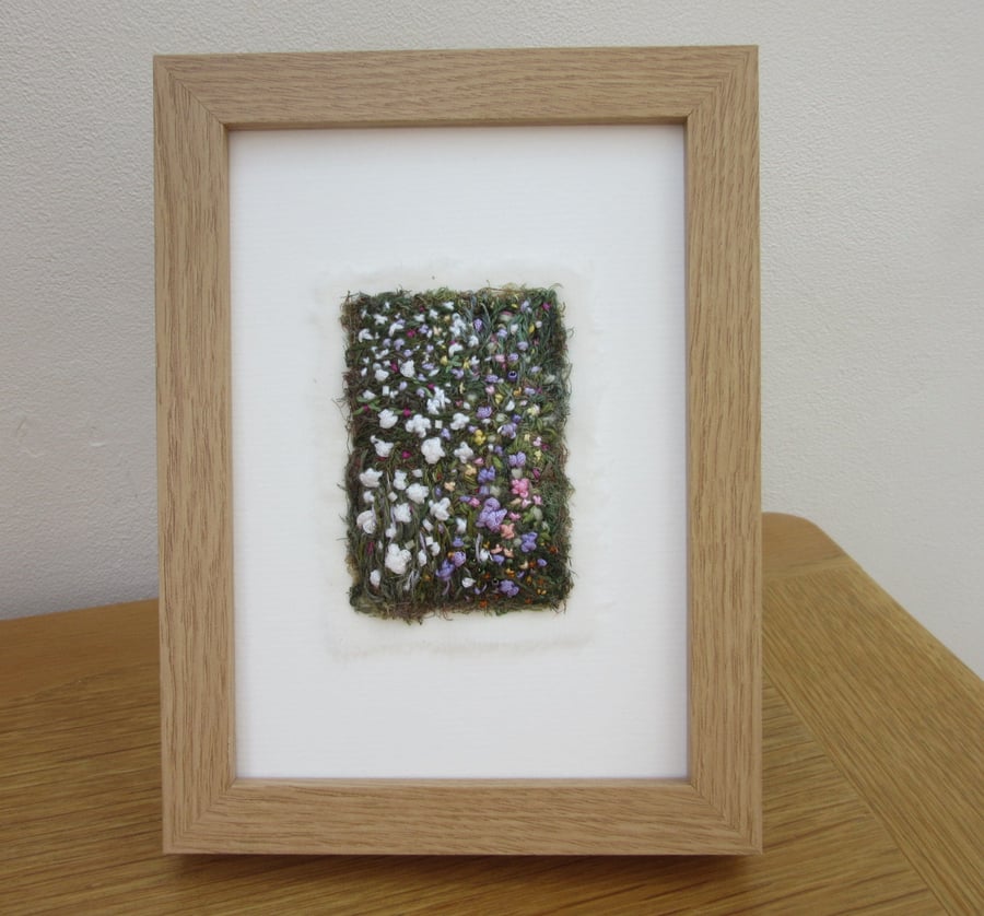 EMBROIDERED GARDEN PICTURE. FRAMED IMPRESSION OF A COTTAGE GARDEN 