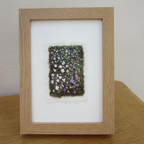 EMBROIDERED GARDEN PICTURE. FRAMED IMPRESSION OF A COTTAGE GARDEN 