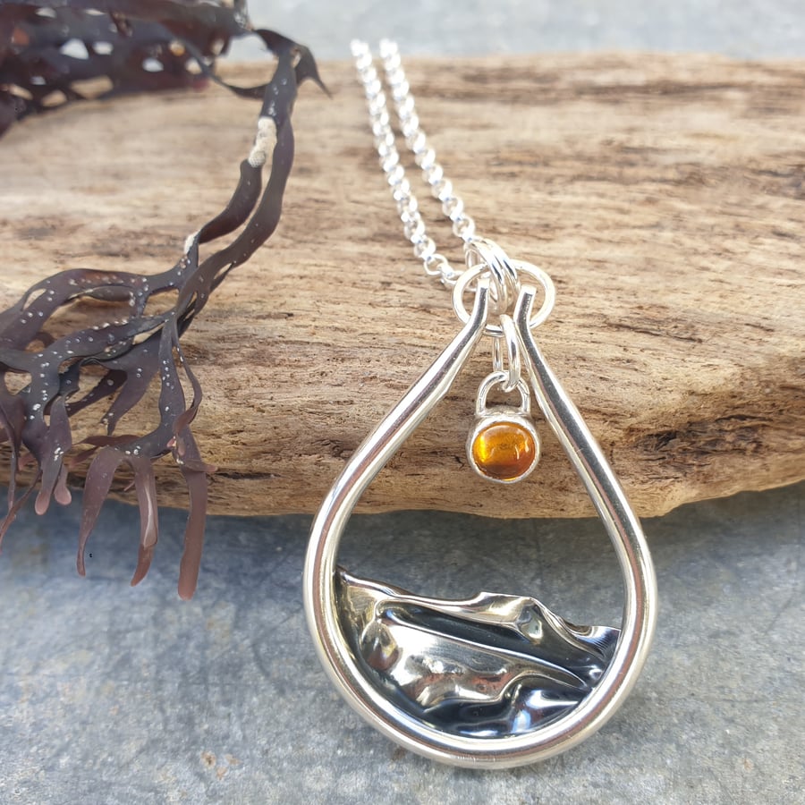 Silver and amber sun rising over sea pendant