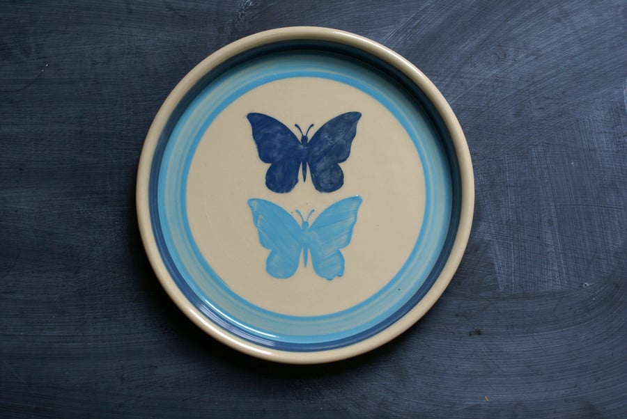 Hand thrown butterfly motif plate in shades of blue