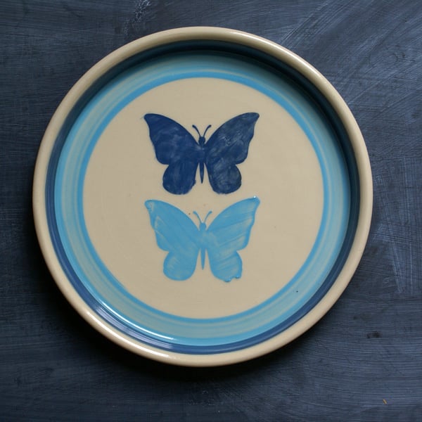 Hand thrown butterfly motif plate in shades of blue