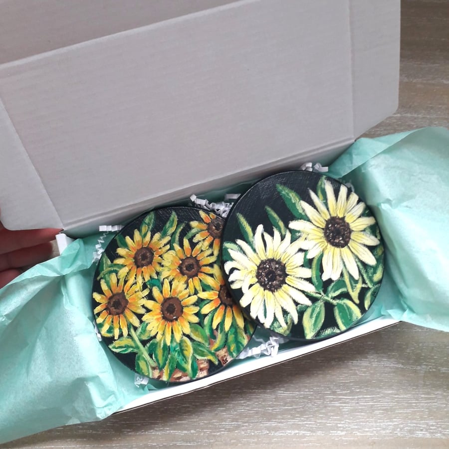 Wooden coasters set of two, each handpainted with a different sunflower plant.  