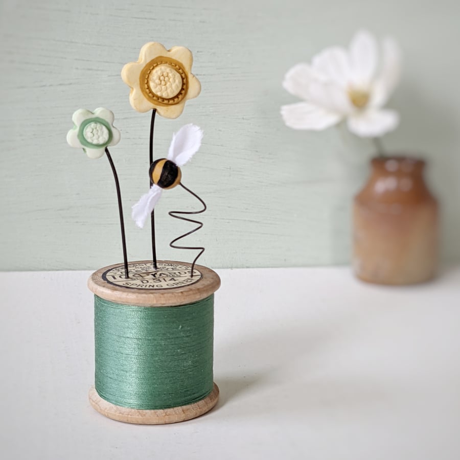 Clay Flowers and Bee on a Vintage Bobbin