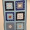 Seconds Sunday. Cotton cot quilt in shades of blue with soft bamboo inner.