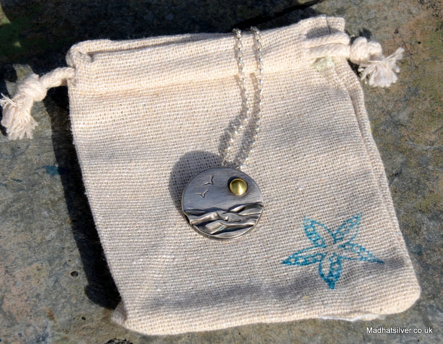 Silver beach, sea pendant, with brass sun and seagulls
