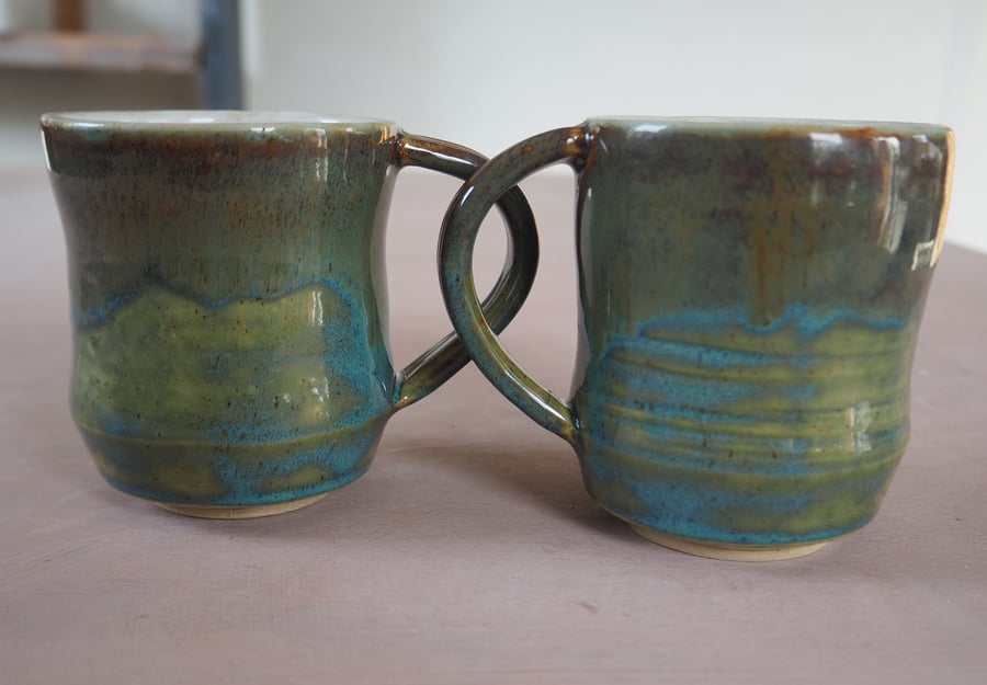  Stoneware pottery mug finished in a turquoise multicolour glaze