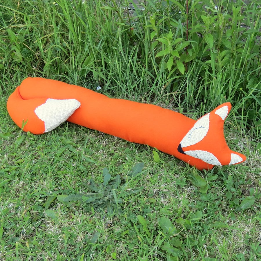Long fox.  A snoozy fox draught excluder in orange wool.