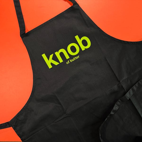 'Knob Of Butter' black apron.
