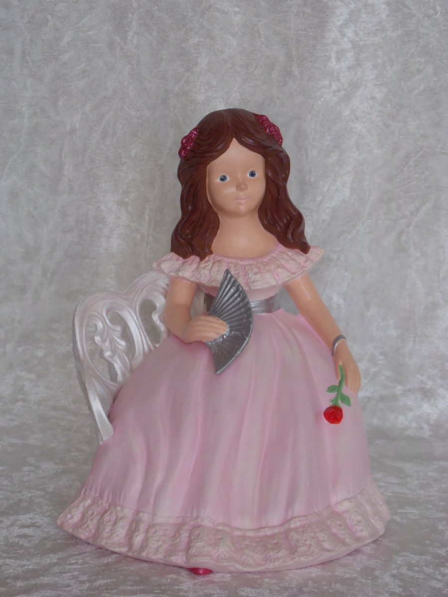 Hand Painted Ceramic Lady Figurine In Pink On A White Garden Seat Ornament.