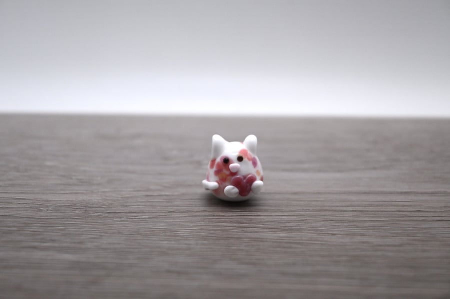 small glass cat figure with heart
